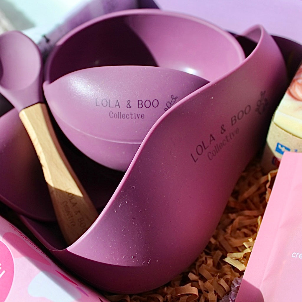 Close-up of Lola & Boo silicone feeder and lip balm in soft pastel tones