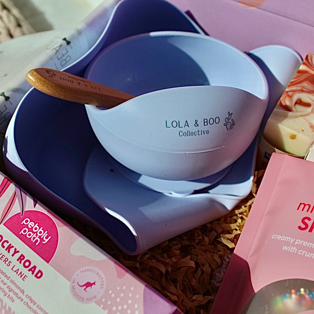 Mum and Bub Beaut Box with baby feeder, treats and skincare items displayed beautifully