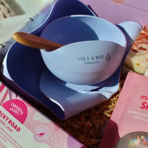 Mum and Bub Beaut Box with baby feeder, treats and skincare items displayed beautifully