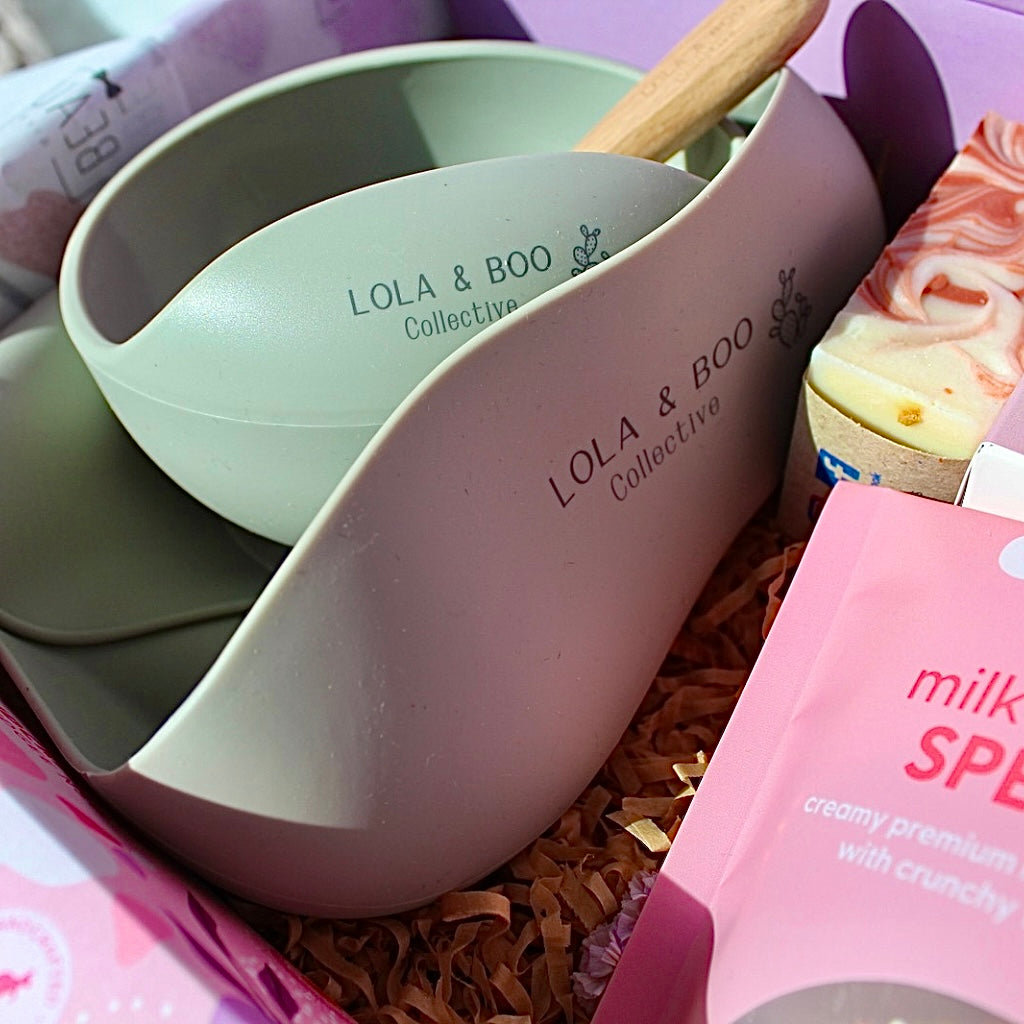 Mum and Bub Beaut Box with baby feeder, treats and skincare items displayed beautifully