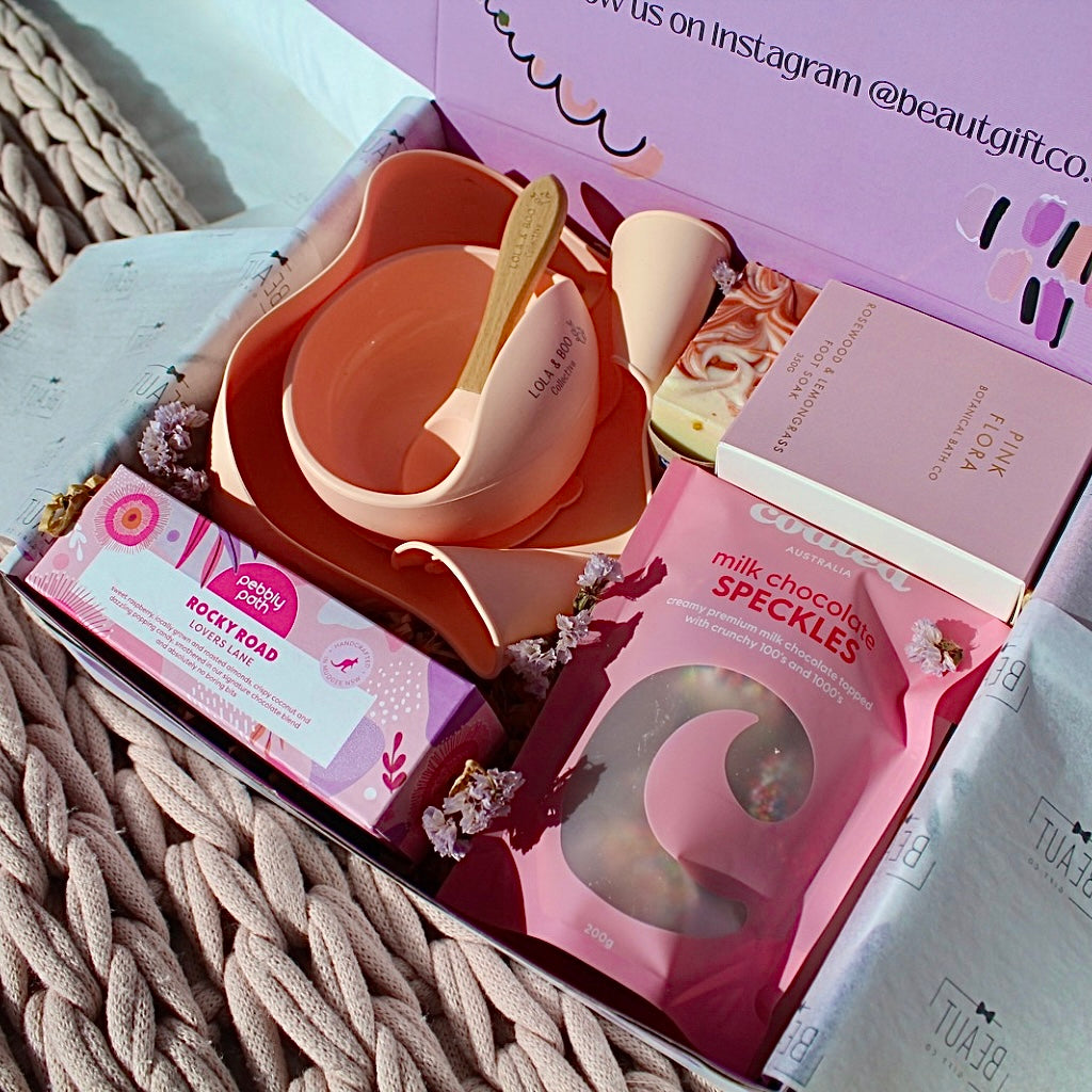 Mum and Bub Beaut Box with baby feeder, treats and skincare items displayed beautifully