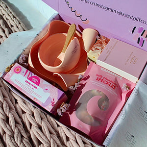 Mum and Bub Beaut Box with baby feeder, treats and skincare items displayed beautifully