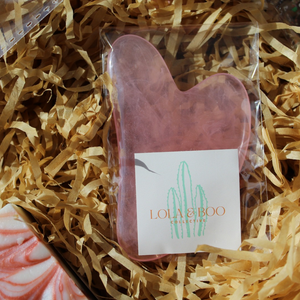 Pink resin Gua Sha massage tool for face and body, designed to boost blood circulation and enhance self-care.