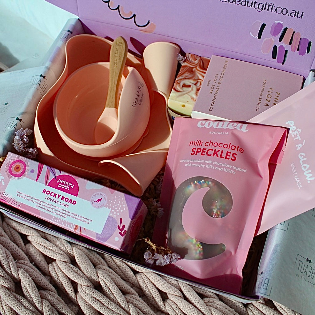 Mum and Bub Beaut Box with baby feeder, treats and skincare items displayed beautifully