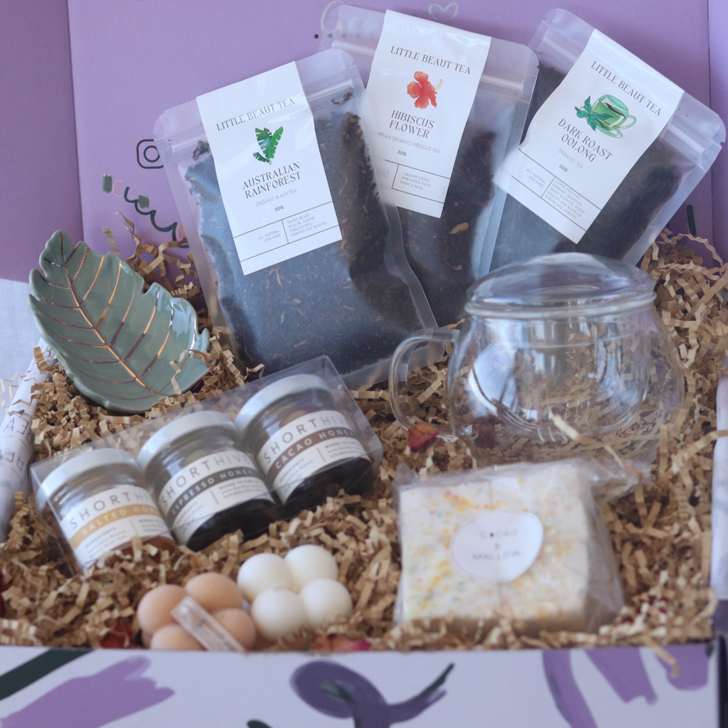tea lovers gift box. filled with three types of tea, honey, candles, marshmallows and tea leaf decor, glass teapot. gift boxes in sydney with free delivery