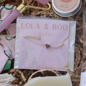 minimalist bracelet with rose gold heart and cream thread