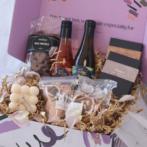 gift box featuring wine chocolate bath salts and candle