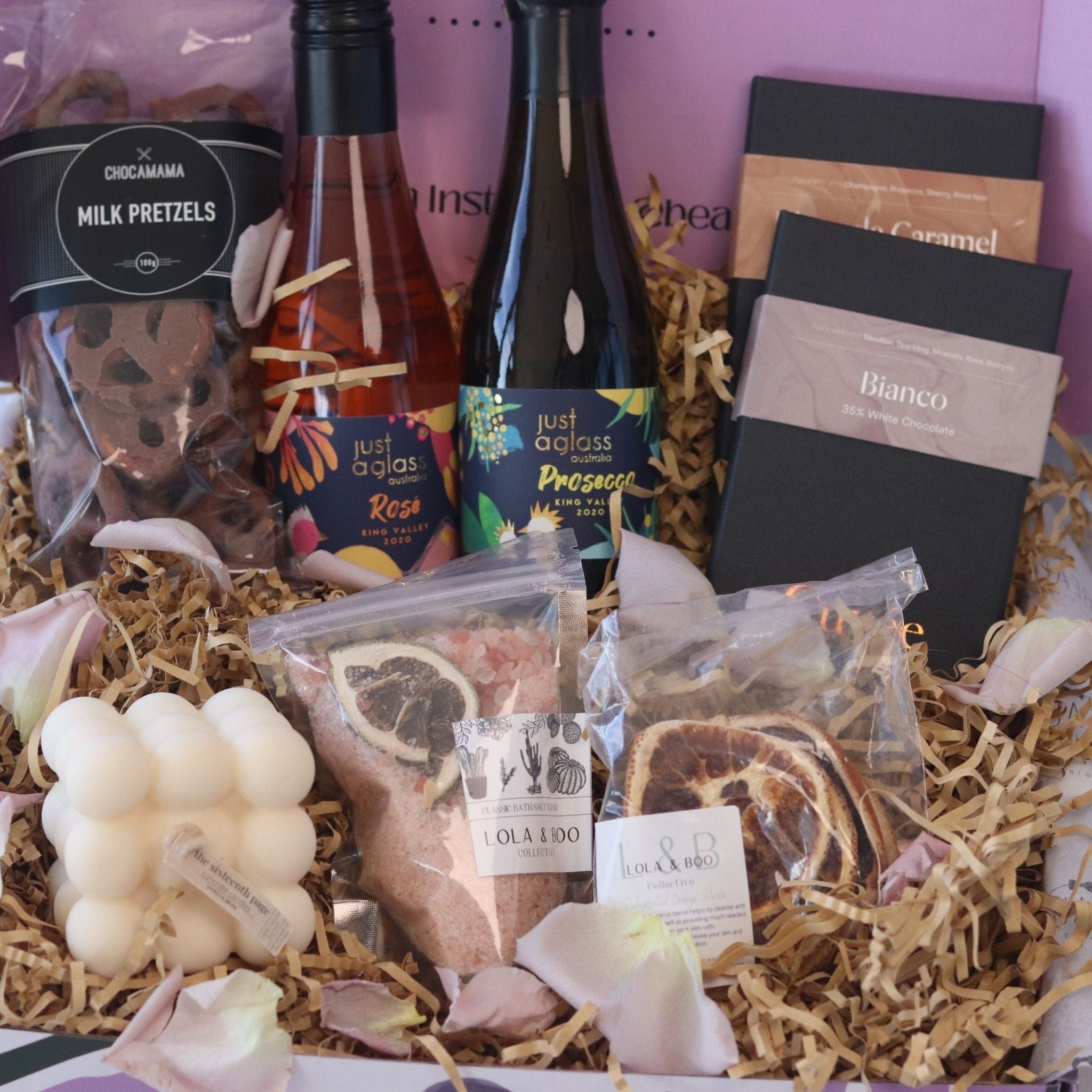 gift box featuring wine chocolate bath salts and candle