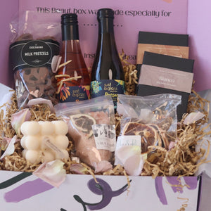 gift box featuring wine chocolate bath salts and candle