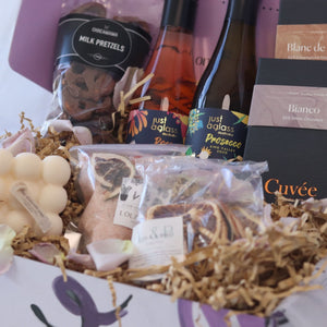 gift box featuring wine chocolate bath salts and candle