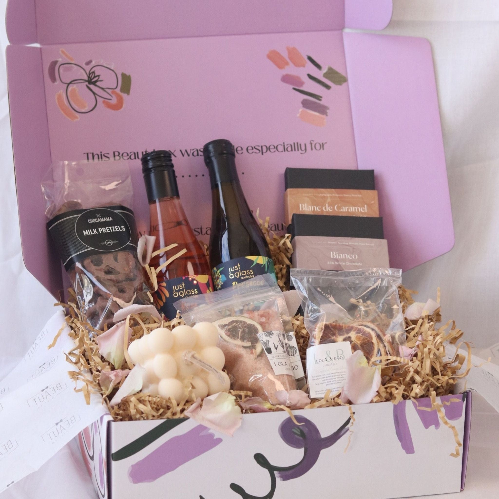 gift box featuring wine chocolate bath salts and candle