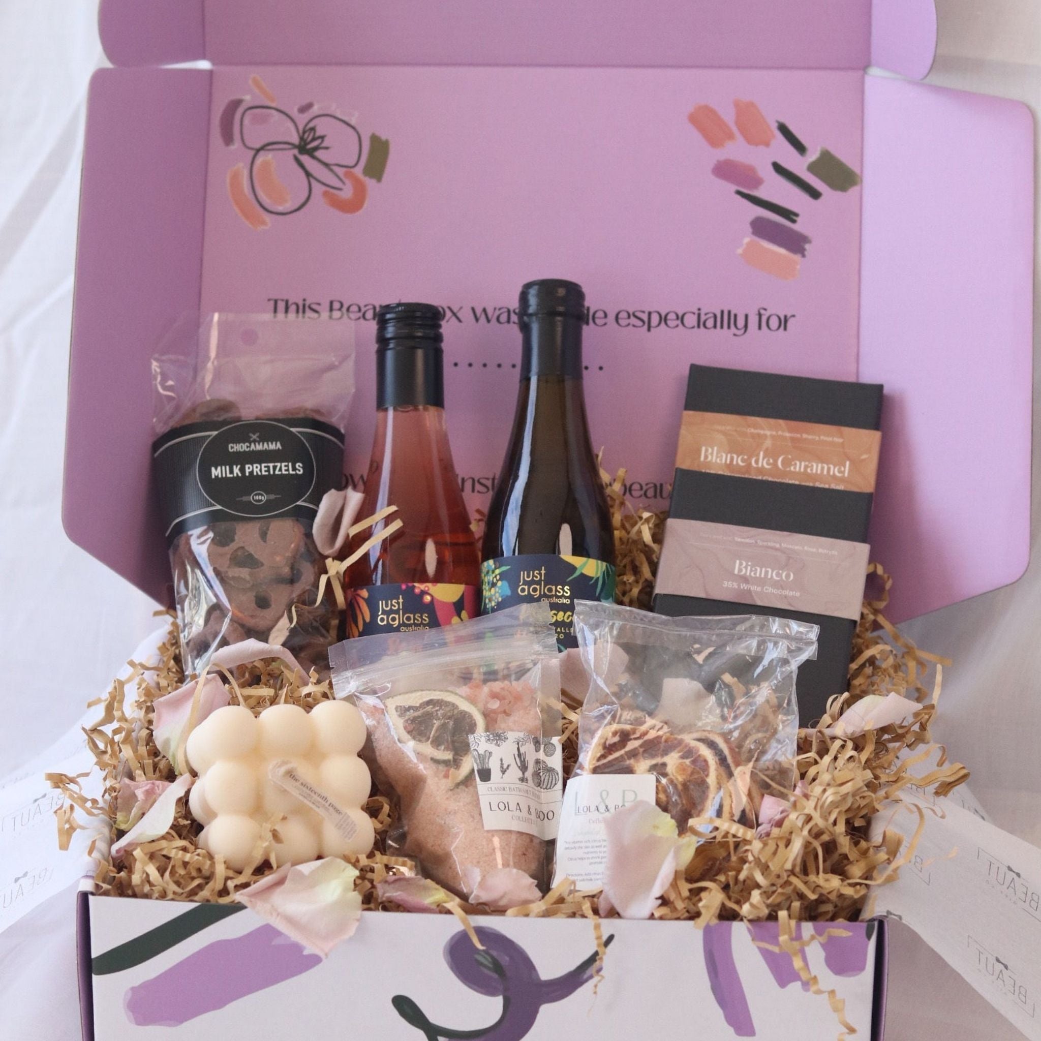 gift box featuring wine chocolate bath salts and candle
