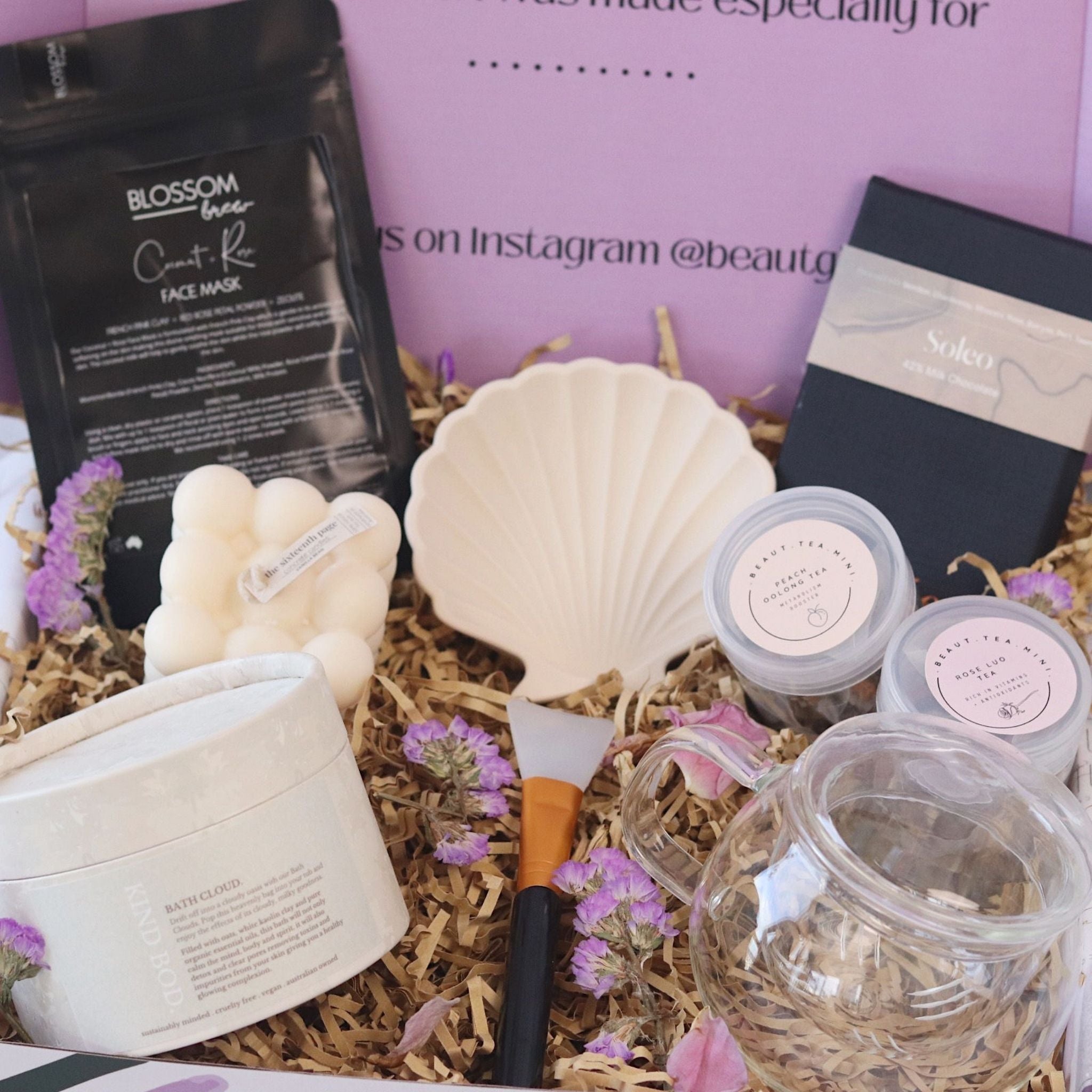 beaut box filled with pamper items, tea, chocolate and home decor