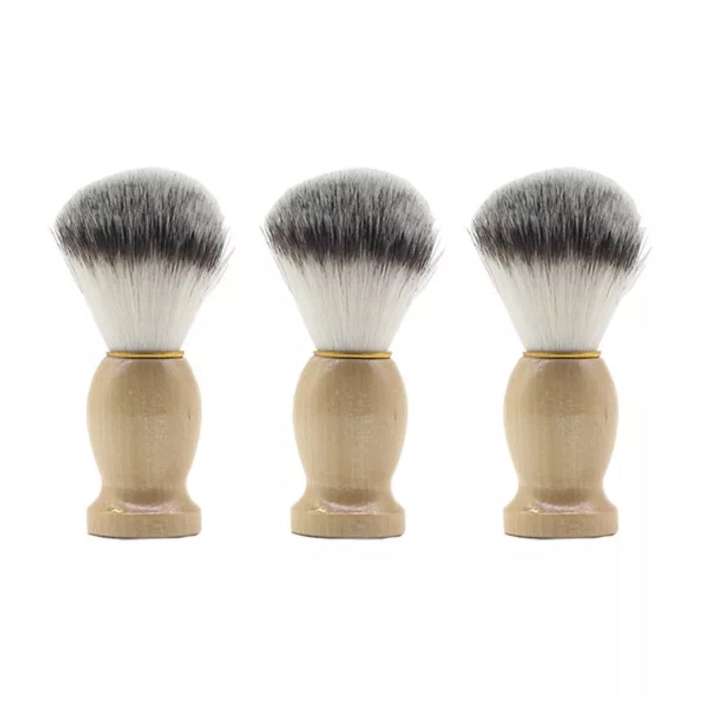mens shaving brush with a ligh handle and white bristles with black on the top