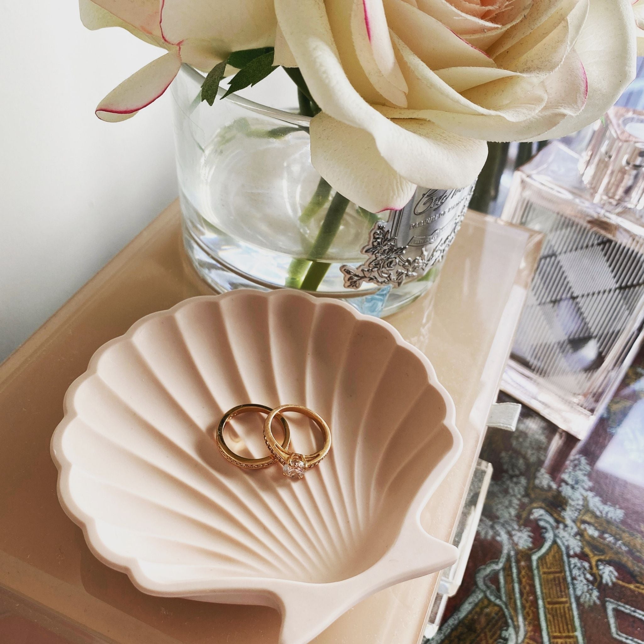 Kirra Home shell dish in light pink, styled with gold rings and trinkets