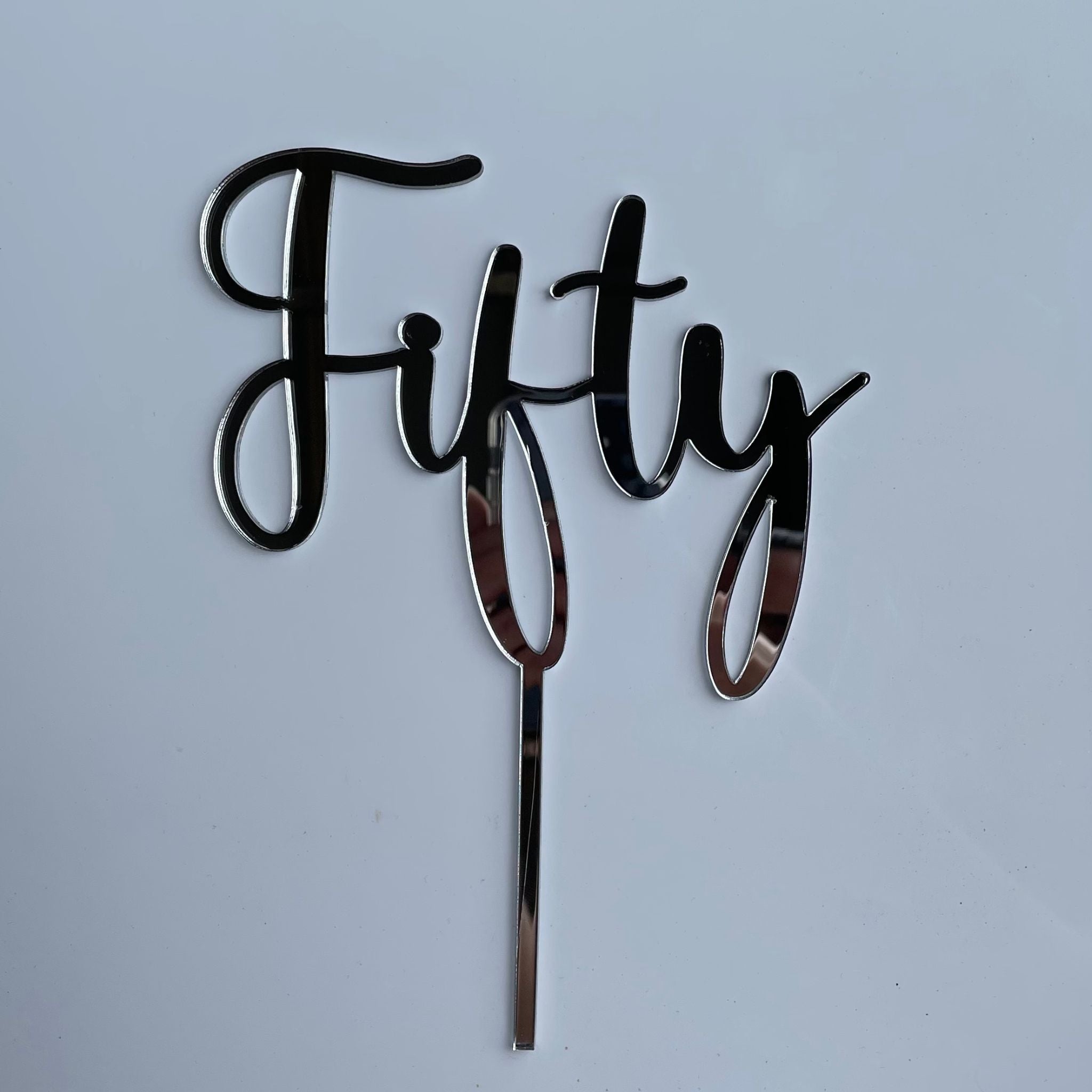 cake topper acrylic that says "fifty"
