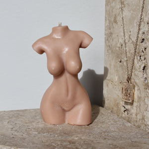 tan nude female body candle